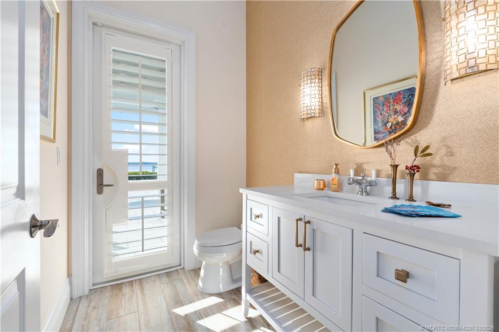 1912 Northwest Cove Circle Stuart, FL 34994 - Photo 20 of 24 a spacious bathroom with a double vanity sink and a mirror