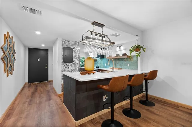 a view of a dining room with furniture and chandelier