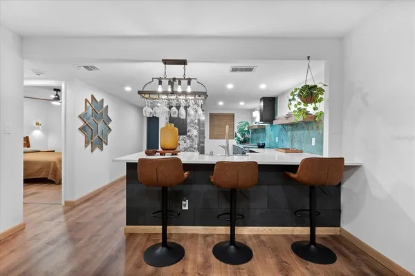 a view of kitchen and dining area with chandelier