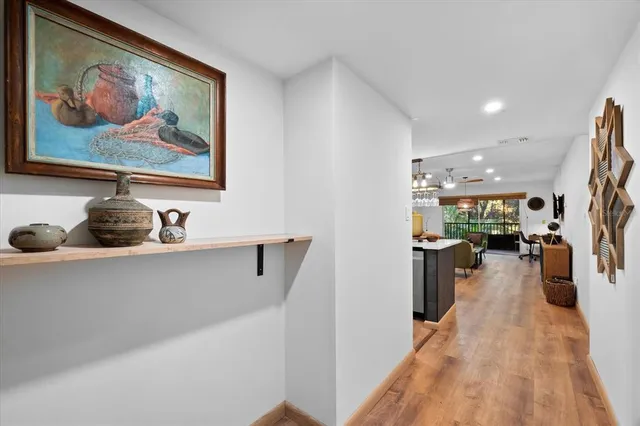 a view of a living room with furniture and wooden floor