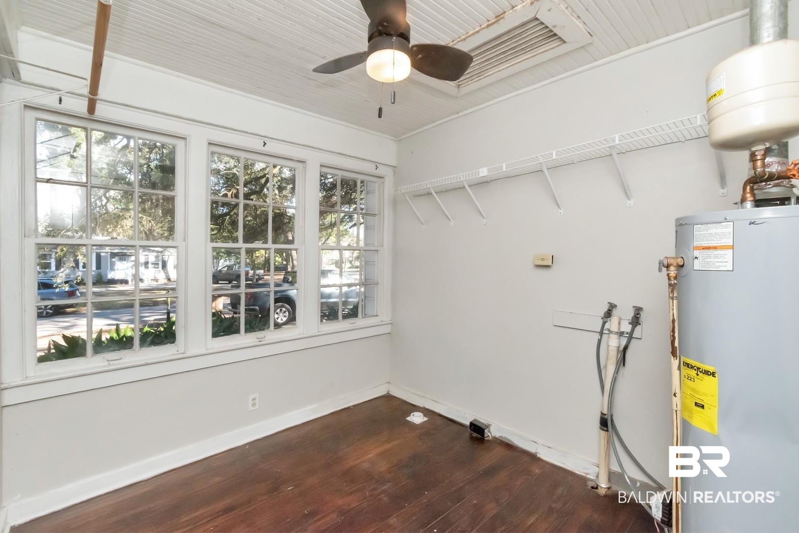 5001 Hillwood Circle South Mobile, AL 36608 - Photo 18 of 20 Washroom featuring a ceiling fan, gas water heater, baseboards, and dark wood-style flooring