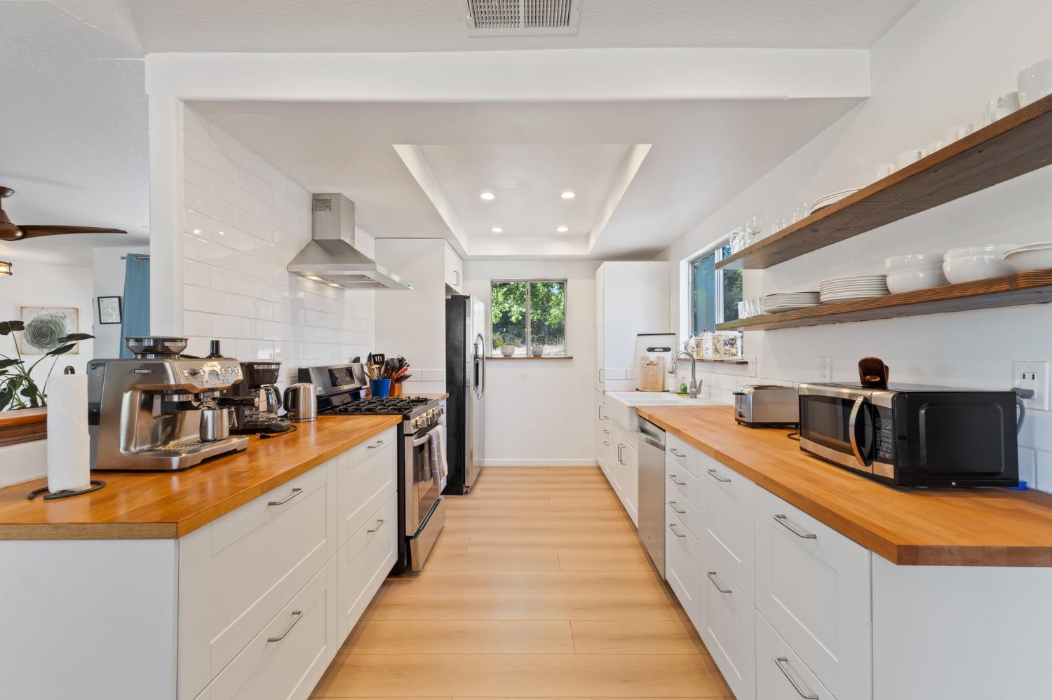 4577 Totokon Road Mariposa, CA 95338 - Photo 11 of 57 a large white kitchen with stainless steel appliances kitchen island granite countertop a large counter top and a view of living room