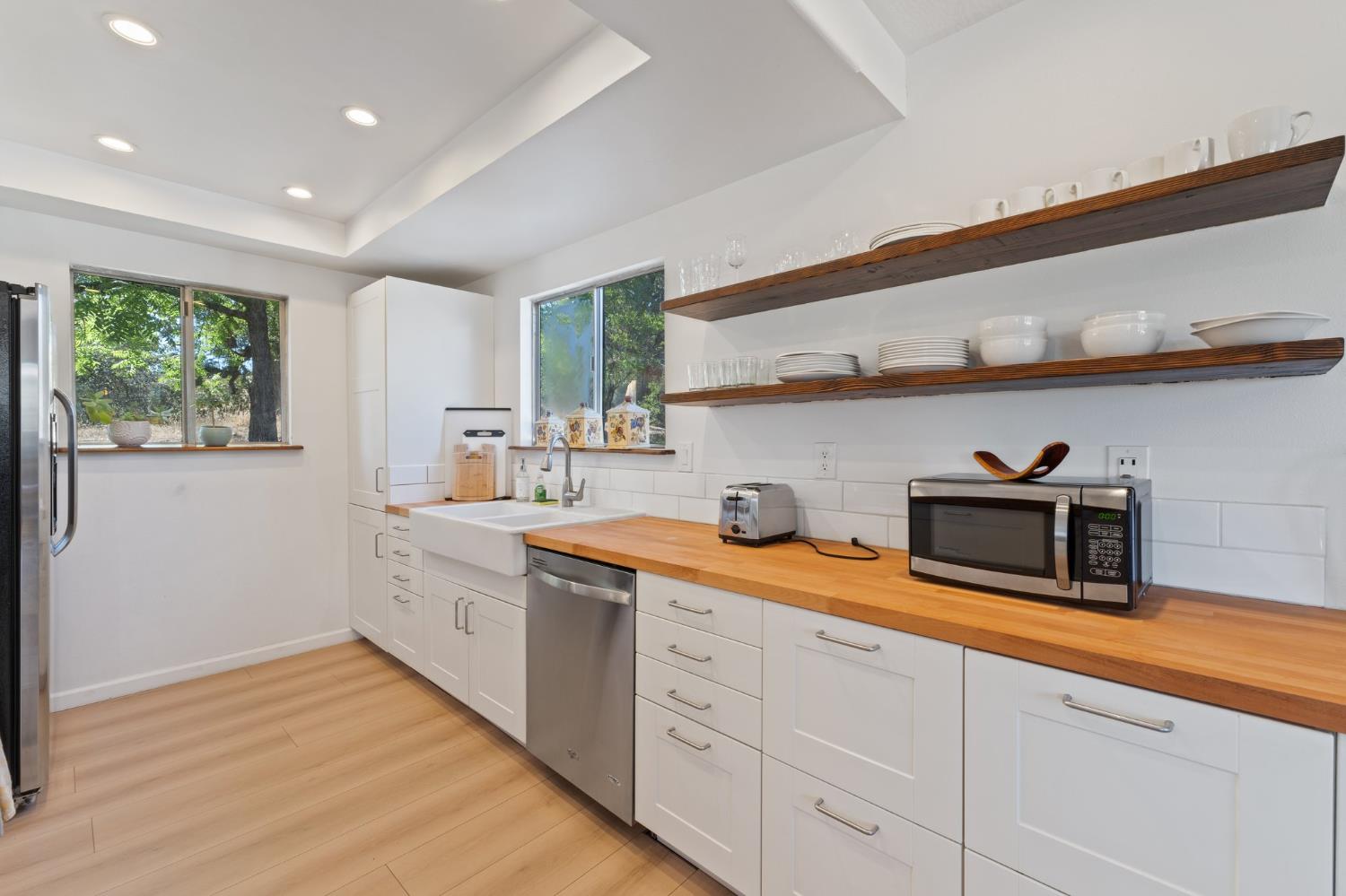 4577 Totokon Road Mariposa, CA 95338 - Photo 13 of 57 a kitchen with stainless steel appliances a sink a stove and cabinets