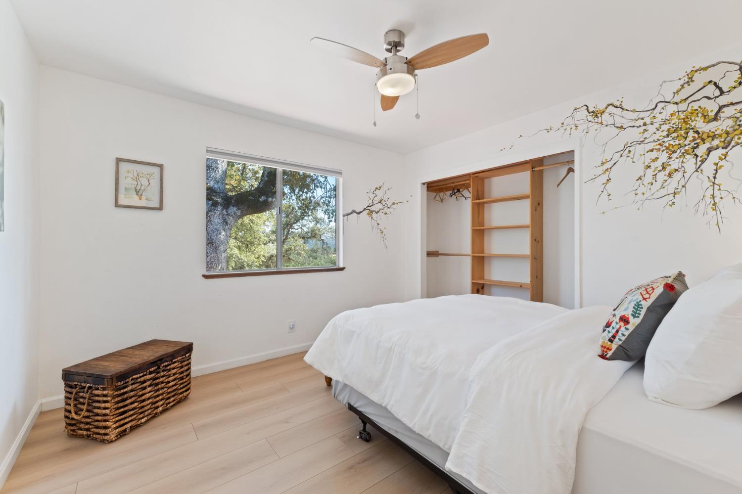 4577 Totokon Road Mariposa, CA 95338 - Photo 28 of 57 a bedroom with a bed and a painting on the wall