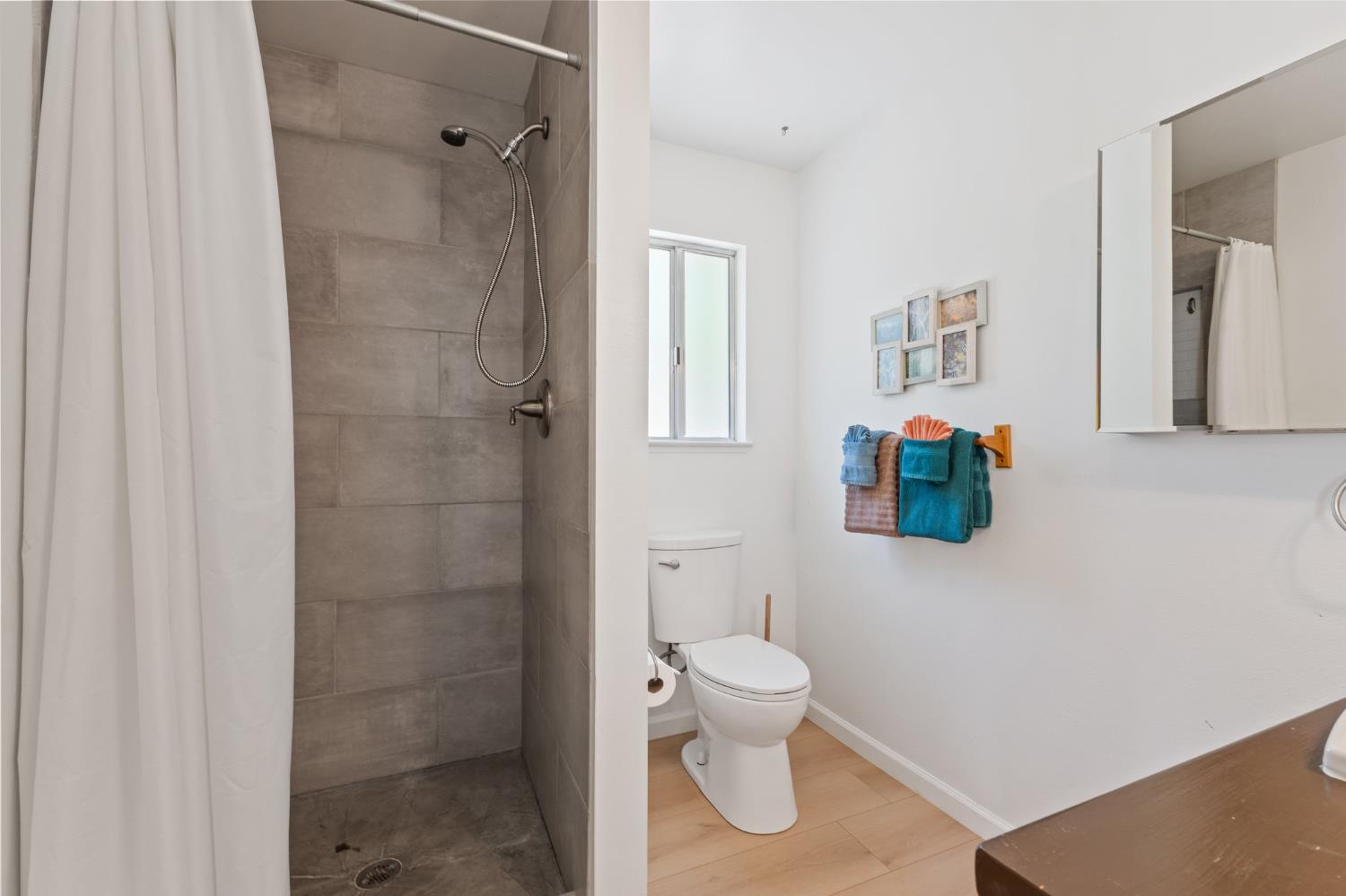 4577 Totokon Road Mariposa, CA 95338 - Photo 30 of 57 a white toilet sitting next to a bathroom sink and vanity