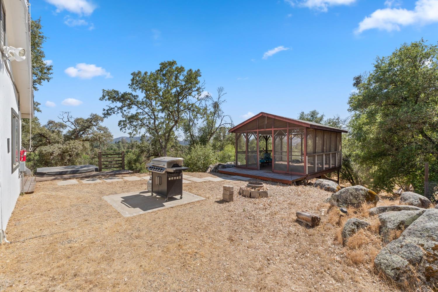 4577 Totokon Road Mariposa, CA 95338 - Photo 37 of 57 a backyard of a house with table and chairs
