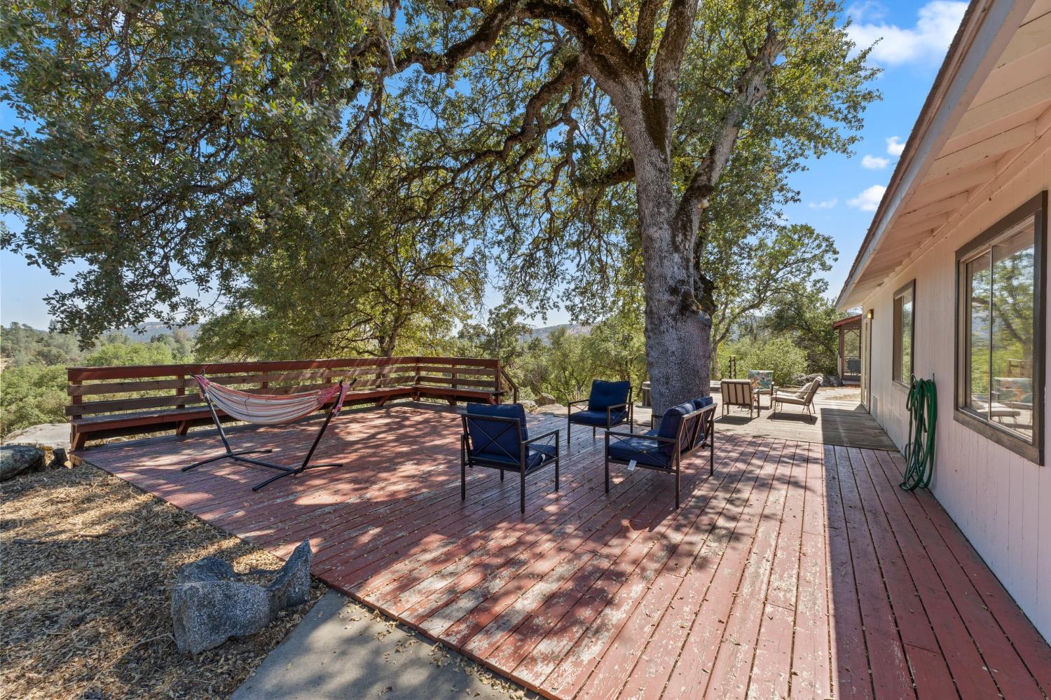 4577 Totokon Road Mariposa, CA 95338 - Photo 46 of 57 a view of a patio with table and chairs and wooden floor