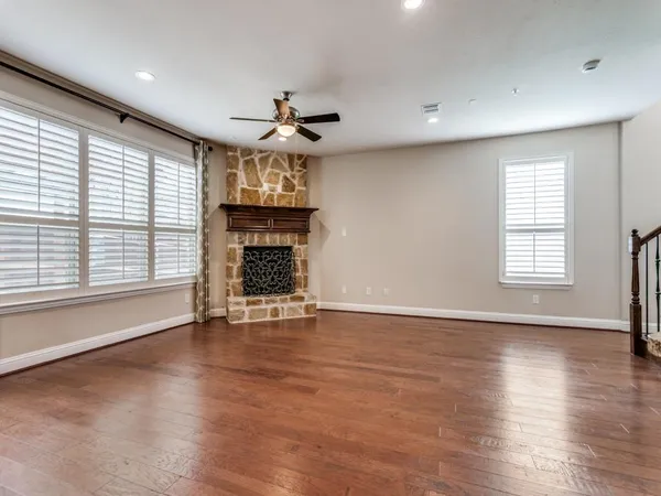 a view of a room with wooden floor chandelier a kitchen view