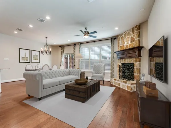 a living room with furniture fireplace and flat screen tv