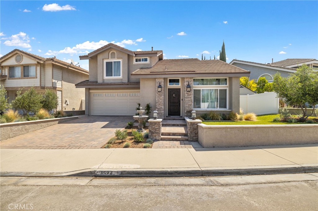 11524 Norgate Circle Corona, CA 92878 - Photo 1 of 1 a front view of a house with a garden and patio