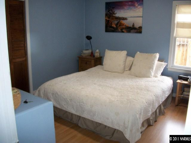 939 Lester Avenue Reno, NV 89502 - Photo 4 of 9 a large bed sitting in a bedroom next to a window