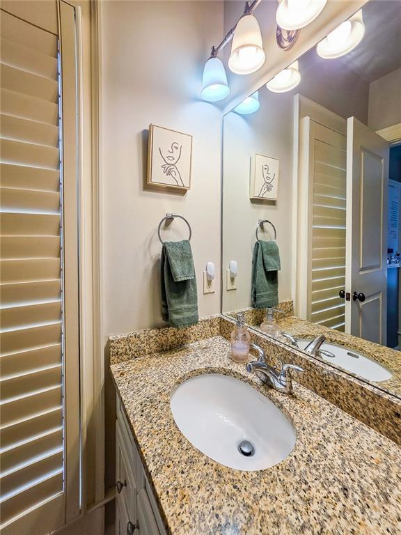 302 Riversgate Drive, Unit 55 Atlanta, GA 30339 - Photo 11 of 40 a bathroom with a granite countertop sink and a mirror