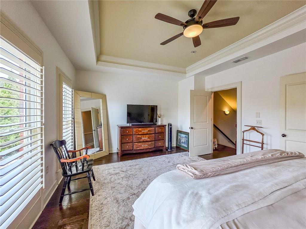 302 Riversgate Drive, Unit 55 Atlanta, GA 30339 - Photo 13 of 40 a bedroom with furniture and a flat screen tv