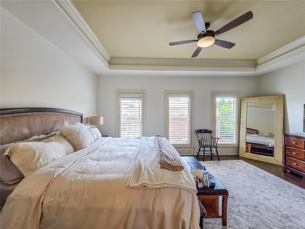 302 Riversgate Drive, Unit 55 Atlanta, GA 30339 - Photo 17 of 40 a bedroom with a bed and a large window with chair