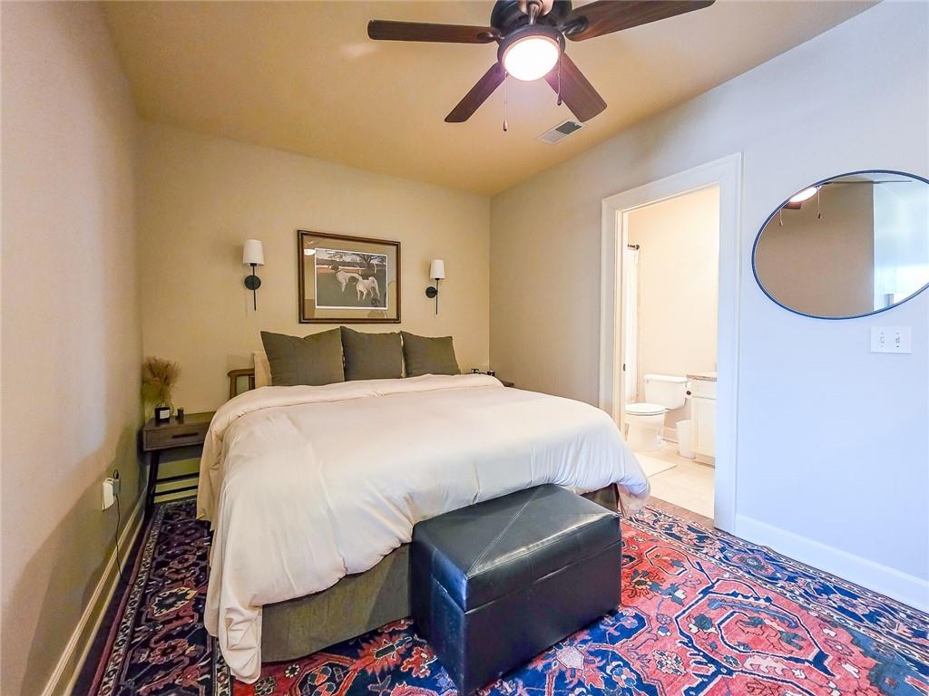 302 Riversgate Drive, Unit 55 Atlanta, GA 30339 - Photo 18 of 40 a bedroom with a bed and a chandelier