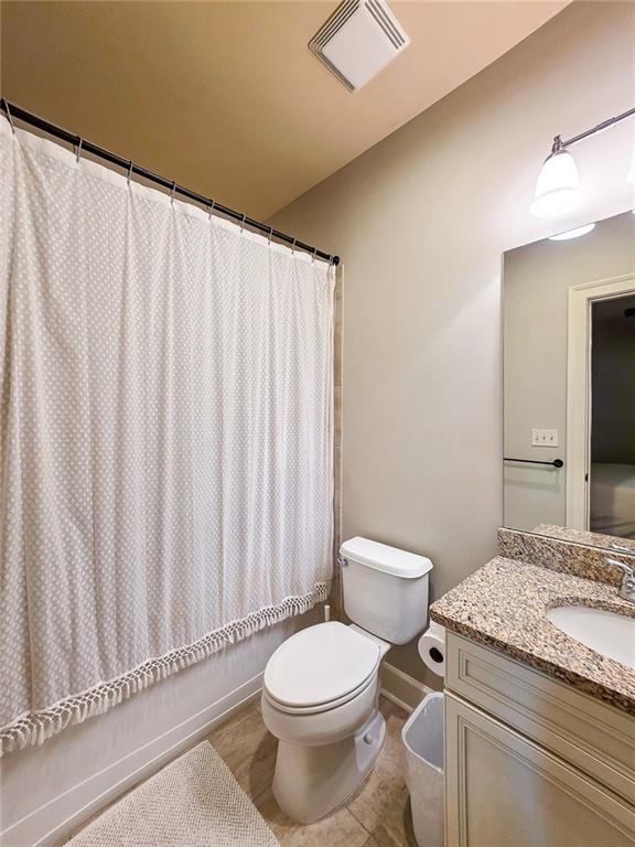302 Riversgate Drive, Unit 55 Atlanta, GA 30339 - Photo 19 of 40 a bathroom with a granite countertop bathtub sink and toilet