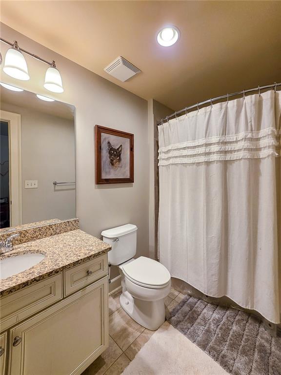 302 Riversgate Drive, Unit 55 Atlanta, GA 30339 - Photo 21 of 40 a bathroom with a granite countertop sink toilet and shower
