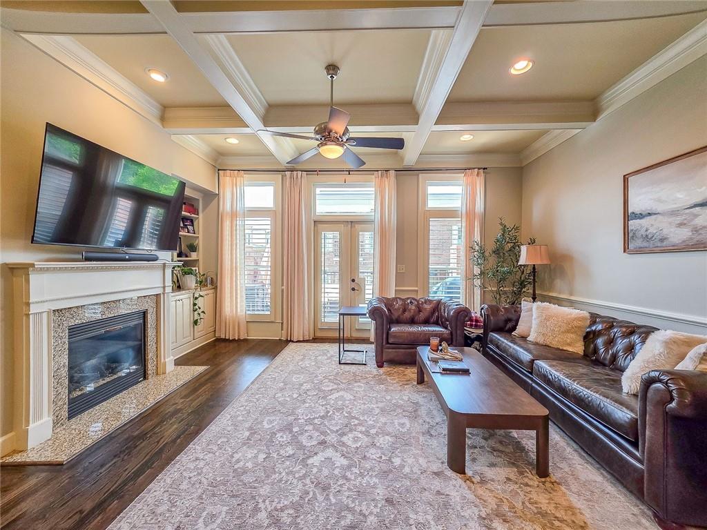 302 Riversgate Drive, Unit 55 Atlanta, GA 30339 - Photo 6 of 40 a living room with furniture a fireplace and a flat screen tv