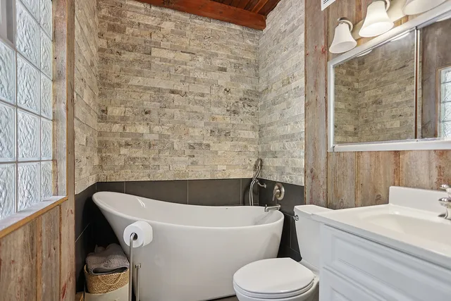 a bathroom with a sink and bathtub with toilet