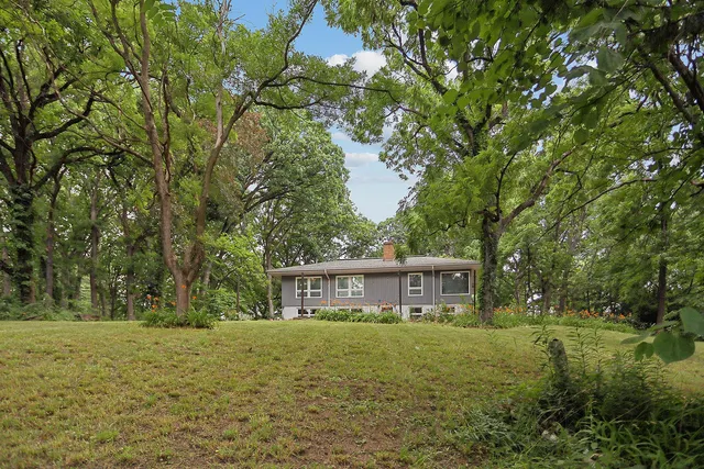 a front view of house with yard and trees