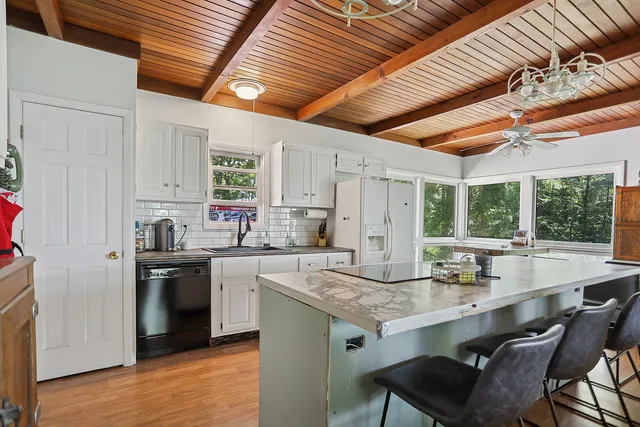 a kitchen with granite countertop stainless steel appliances a sink and cabinets