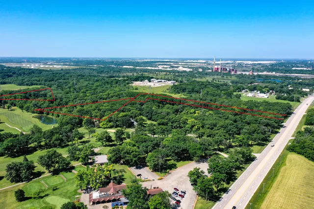 an aerial view of a city with lots of residential buildings and mountain view in back