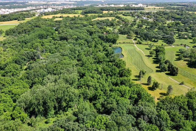 an aerial view of a city with lots of residential buildings and mountain view in back