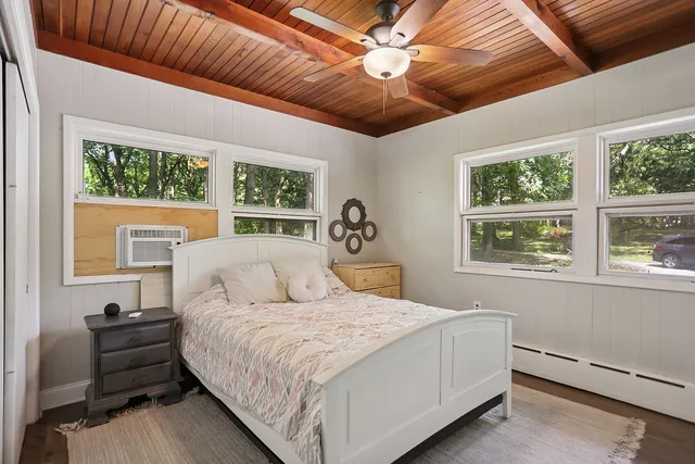 a bedroom with a large bed and a window