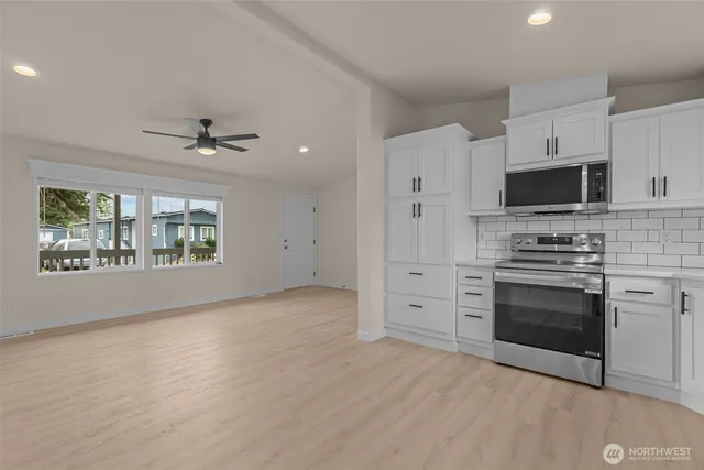 a kitchen with stainless steel appliances a stove microwave and a refrigerator