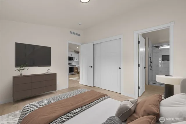 a bedroom with a bed and a flat screen tv