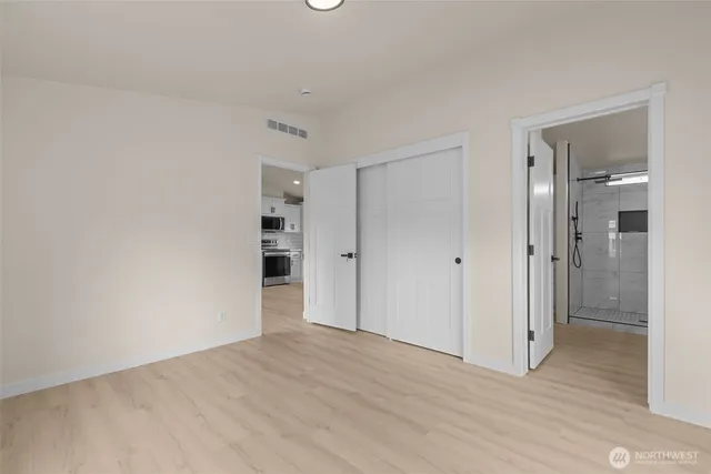 a view of empty room with wooden floor