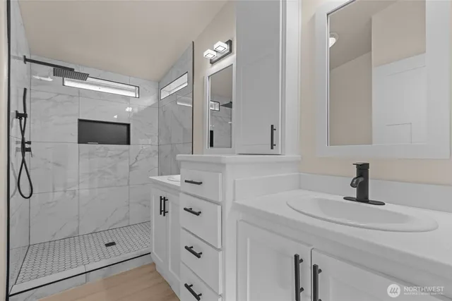 a bathroom with a sink a toilet and shower