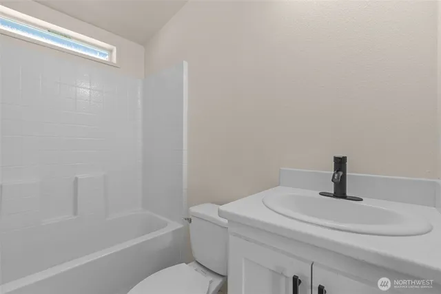 a bathroom with a sink a toilet and bathtub