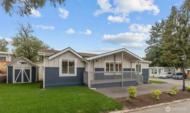 a front view of a house with a garden and yard