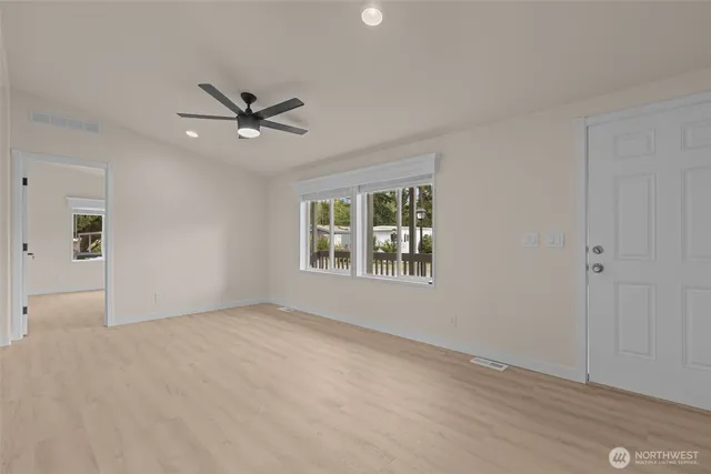 a view of a livingroom with a ceiling fan and window