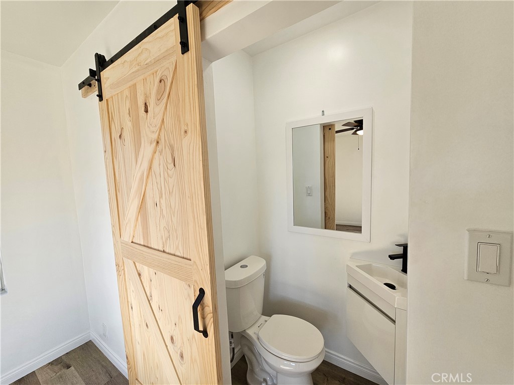 401 West School Street Compton, CA 90220 - Photo 1 of 1 a bathroom with a shower a toilet and a window