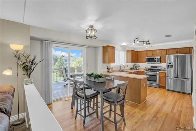 a kitchen with refrigerator a stove and cabinets