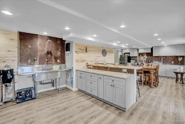a large white kitchen with lots of counter space a sink and appliances