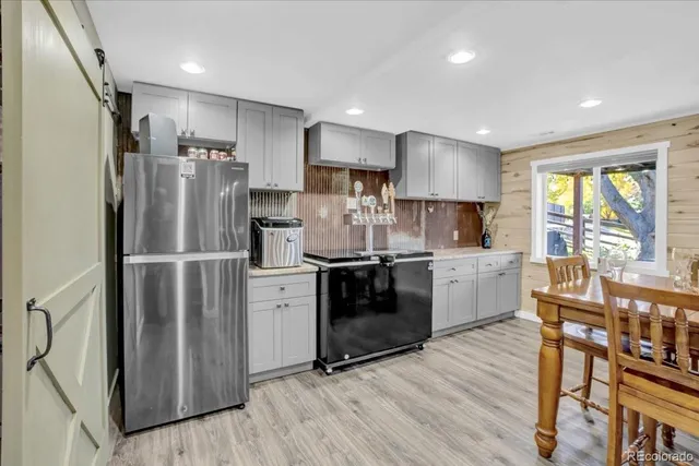 a kitchen with stainless steel appliances a refrigerator sink and microwave