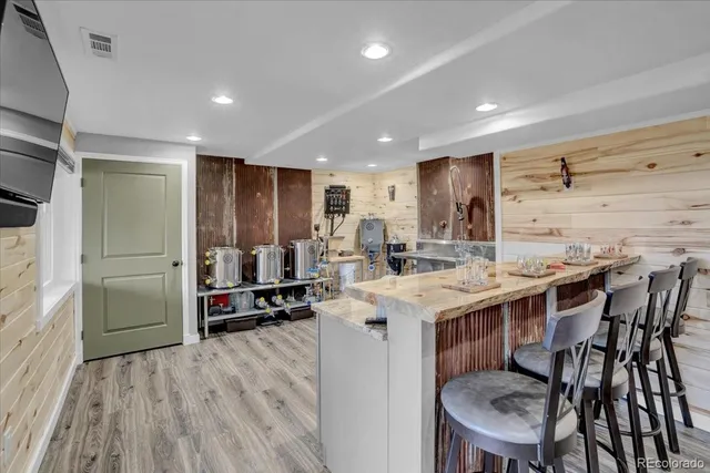 a kitchen with a table chairs refrigerator and cabinets