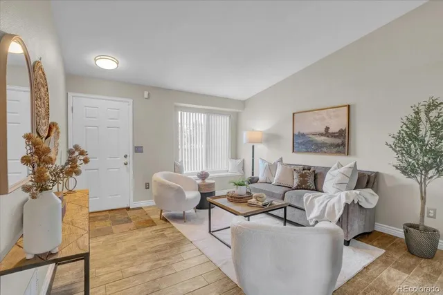 a living room with furniture and a potted plant