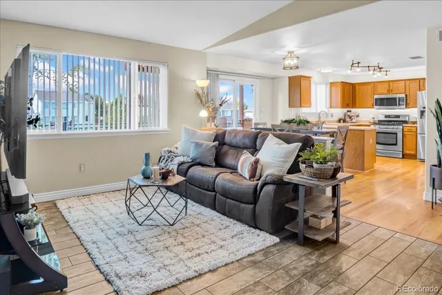a living room with fireplace furniture and a window