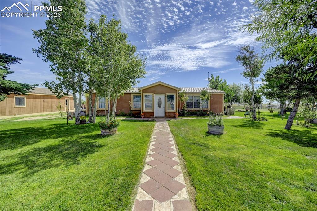 35875 Shear Road Yoder, CO 80864 - Photo 2 of 45 a front view of house with yard and green space