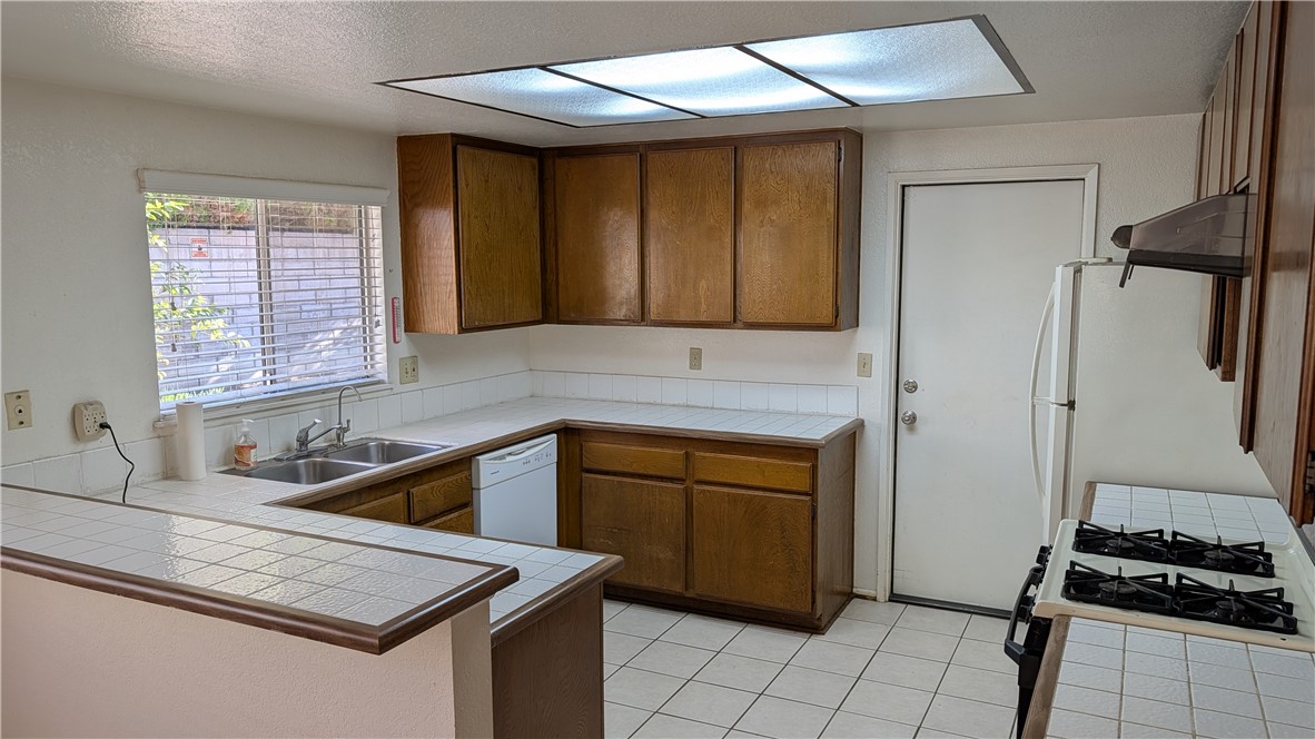 19143 East Aurora Drive Walnut, CA 91789 - Photo 9 of 27 a kitchen with a sink stove and refrigerator