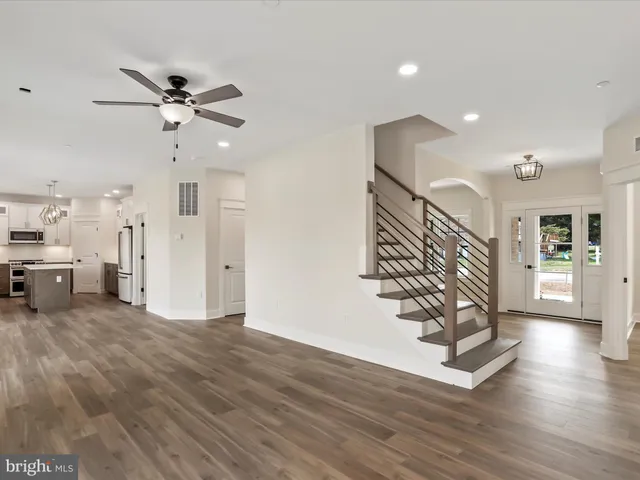 a large kitchen with granite countertop a large counter top appliances and cabinets
