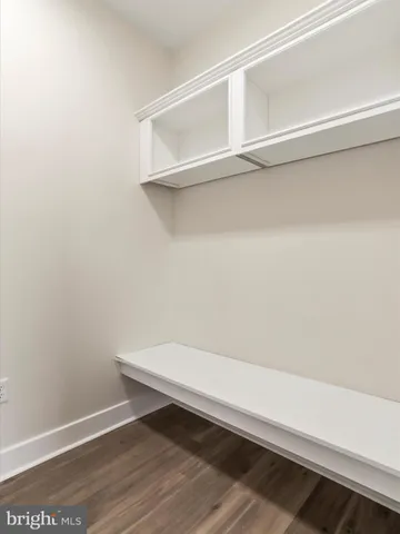 a view of a hallway view with wooden floor and staircase