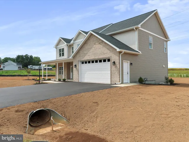 a view of a house with a yard and palm trees