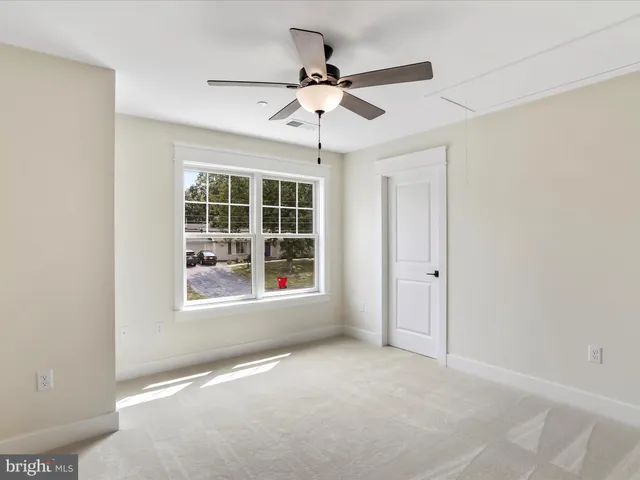 a bathroom with a bathtub shower sink vanity mirror and toilet