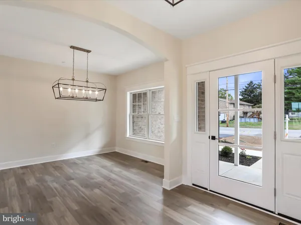 a view of a room with wooden floor and windows