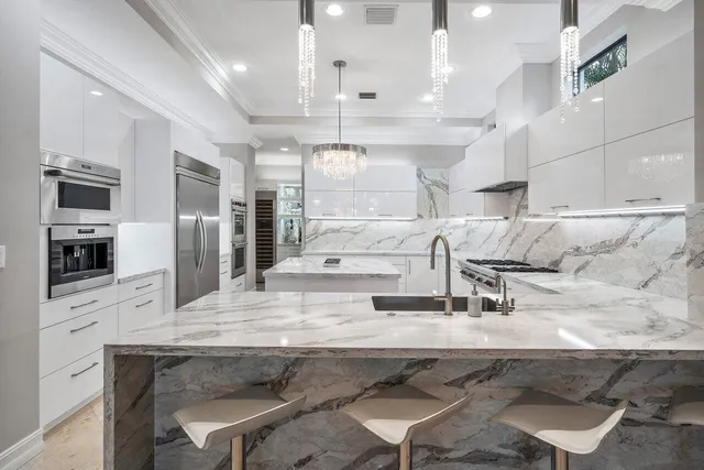 a kitchen with a stove and a white cabinet with wooden floor